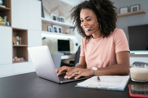 beautiful afro american woman using laptop at home for online video call